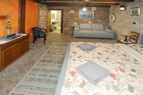 a large bed in a living room with a couch at Ferienwohnung Sonja mit Meerblick in Sečovlje