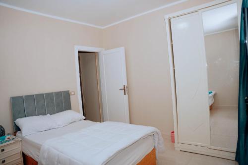 a bedroom with a bed and a large mirror at Tranquil Villa in Fayoum Private Pool Garden Lake Access in Kaḩk al Baḩrīyah