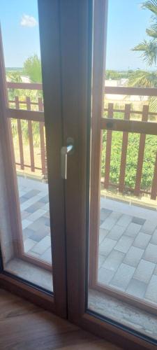 a sliding glass door with a view of a balcony at VALERIA'S HOUSE in Terlizzi