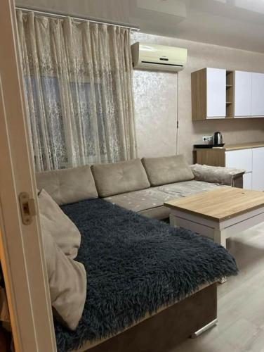 a living room with a couch and a table at Odessa Apartments free parking in Odesa