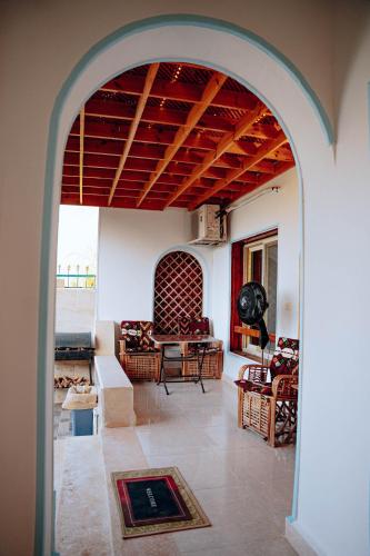 an archway leading into a living room with a couch at Tranquil Villa in Fayoum Private Pool Garden Lake Access in Kaḩk al Baḩrīyah