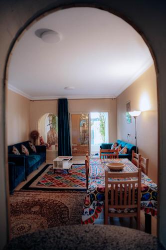 a living room with a couch and a table at Tranquil Villa in Fayoum Private Pool Garden Lake Access in Kaḩk al Baḩrīyah