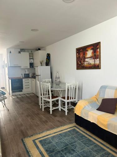 a bedroom with a bed and a table and a kitchen at Ocean House in Santa Cruz