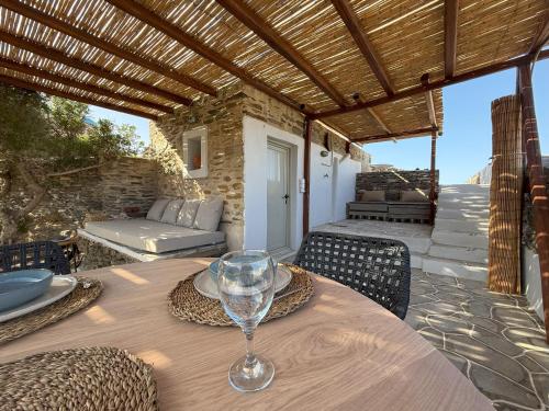 a wooden table with a wine glass on a patio at Mill House in Kastron