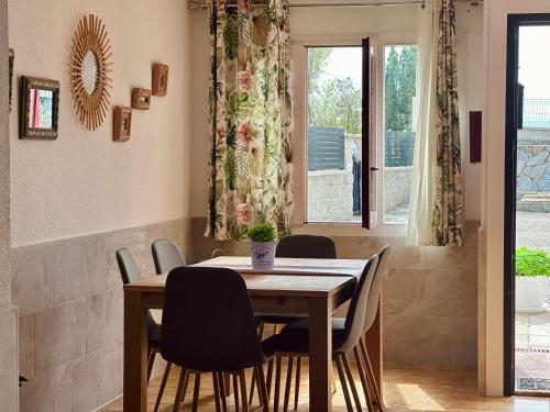 a dining room with a wooden table and chairs at A Babor - 20805 in Argoños