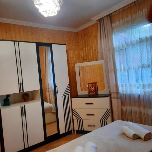 a bedroom with a bed and a dresser and a mirror at Nugzar House Chakvi - 2 Bedrooms in Chakvi