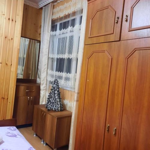 a christmas tree sitting on a table next to a window at Nugzar House Chakvi - 2 Bedrooms in Chakvi