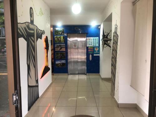 a hallway of a building with paintings on the walls at Apartahotel del Paseo in San José