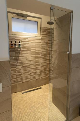a shower with a glass door in a bathroom at Luna Luxury Suite in Bergamo