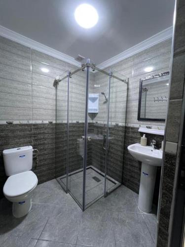 a bathroom with a shower and a toilet and a sink at Casa del Mar in Asilah