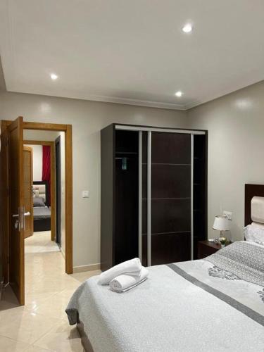 a bedroom with two beds and a sliding glass door at Casa del Mar in Asilah