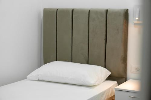 Una cama o camas en una habitación de Tepelena Center Hotel
