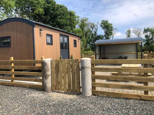 a fence in front of a tiny house at Rose Valley Ballycastle in Ballycastle