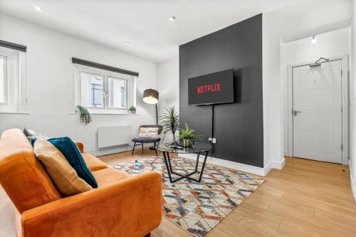 a living room with a couch and a table at Heart of the City Centre - Serviced Apartments in Manchester