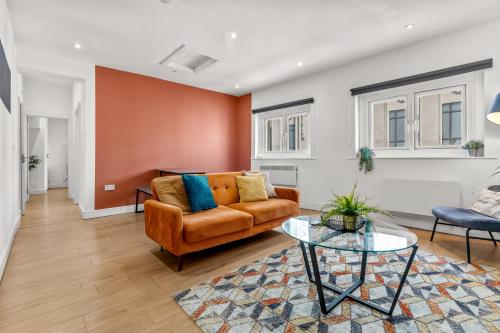 a living room with a couch and a glass table at Heart of the City Centre - Serviced Apartments in Manchester