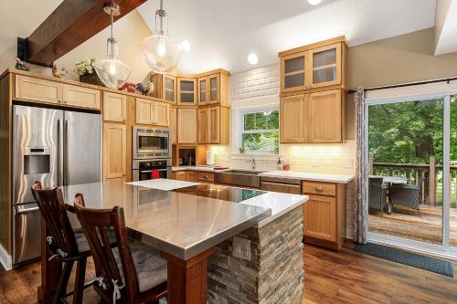 a kitchen with wooden cabinets and a large island at Maple City Farm Pet Friendly in Maple City