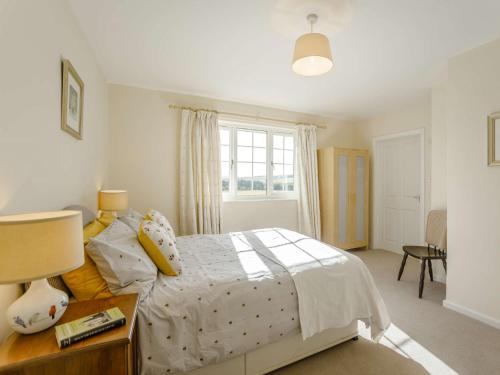 a bedroom with a bed and a table and a window at 2 Bed in Mindrum 85422 in Carham