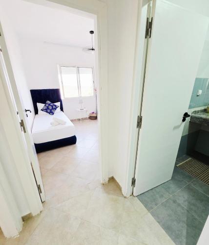 a bedroom with a bed and a room with a mirror at 5-star hillside relaxation in Imi Ouaddar