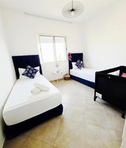 a room with two beds and a couch in it at 5-star hillside relaxation in Imi Ouaddar