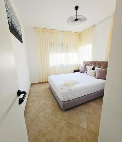 a bedroom with a bed in a room with a window at 5-star hillside relaxation in Imi Ouaddar