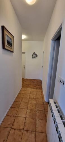 a hallway with a tile floor in a room at ALIANA apartment in Sečovlje