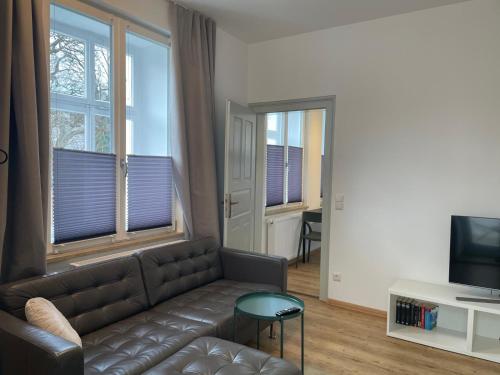 Télévision ou salle de divertissement dans l'établissement SCHEE Apartments am Löpsinger Tor