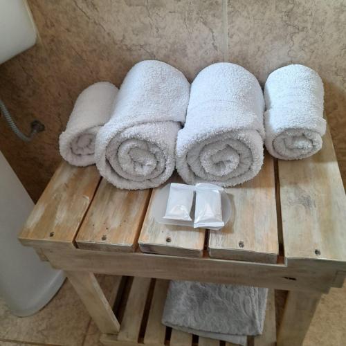 a pile of towels on a wooden table in a bathroom at Bella Vista in Valle Hermoso