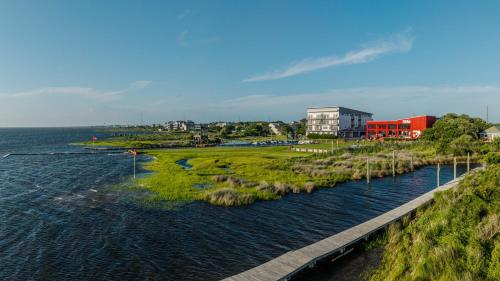 a body of water with a bridge and a building at S-Turns - 3-Bedroom, 3-Bathroom Suite at REAL Watersports in Waves