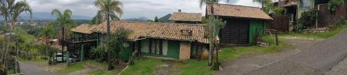 an aerial view of an old house and a street at Pousada vale verde bungalows - Praia do Rosa in Praia do Rosa