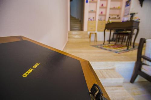 a laptop computer sitting on top of a table at Kalkan Kleo Pension Guesthouse in Kalkan
