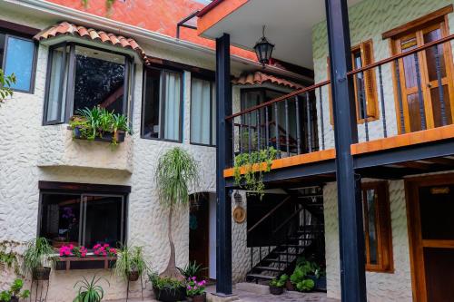 a building with potted plants on the side of it at Casa Real Coyoacán in Mexico City