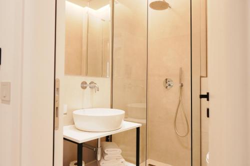 a bathroom with a sink and a shower at Hotel Mediterrane in Sarandë