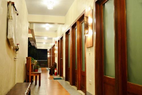 a hallway of a building with wooden doors and a dog at Agos Boracay Rooms + Beds in Boracay