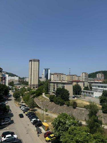 a city street with cars parked in a parking lot at Aparman Stupine in Tuzla