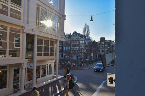 a view of a city street with people and buildings at NEW cosy apartment in 9 streets in Amsterdam