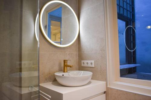 a bathroom with a sink and a mirror at NEW cosy apartment in 9 streets in Amsterdam