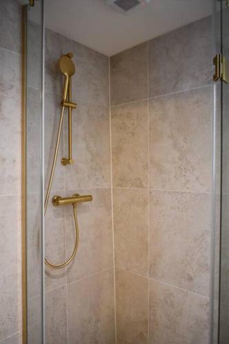 a shower with a glass door in a bathroom at NEW cosy apartment in 9 streets in Amsterdam