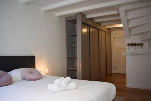 a bedroom with a bed with two towels on it at NEW cosy apartment in 9 streets in Amsterdam