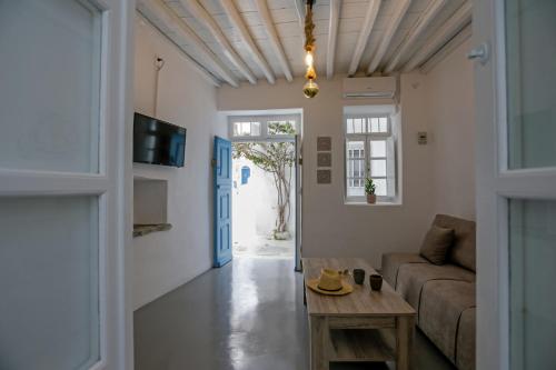 a living room with a couch and a table at Magic holidays 111 in Tourlos