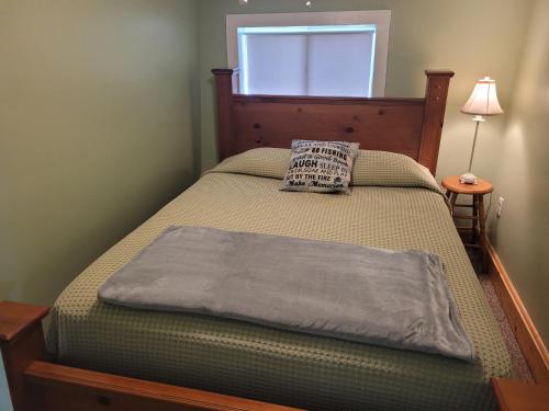a bed in a bedroom with a pillow on it at The Turk Lake House - Lakefront With Toys & Ac! in Greenville