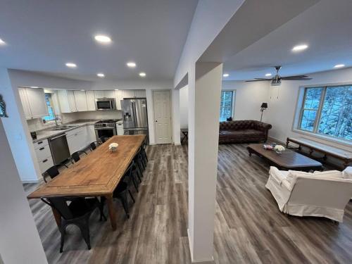 a kitchen and living room with a table and a couch at Wolf Pond 2 ONLY 3 Miles to Lake Placid in Lake Placid