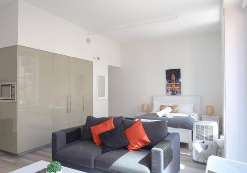 a living room with a couch and a bed at The Clocktower Light and Airy Studio on Bourke St in Melbourne