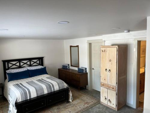 a bedroom with a bed and a mirror and a dresser at Wolf Pond 1 - 3 Miles to Lake Placid NY in Lake Placid