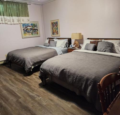 a bedroom with two beds in a room at Tortuga Inn in Winamac