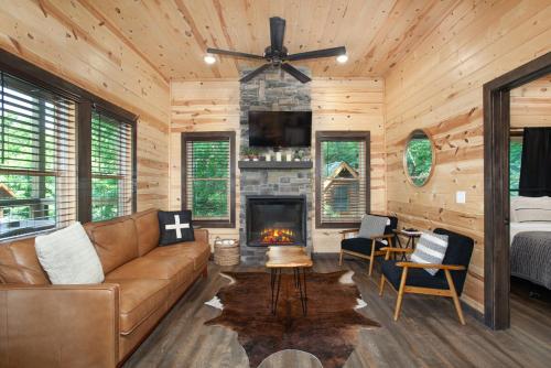 a living room with a couch and a fireplace at Smoky Ridge Hideaway Views Hot Tub Game Room in Sevierville