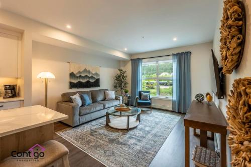 a living room with a couch and a table at Rivers Edge, Mtn Views, AC, BBQ, King Bed in Golden