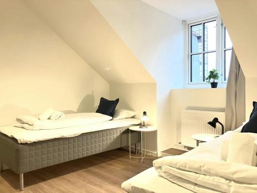 a bedroom with two beds and a window at Spacious Apartment for 4 in Esbjerg