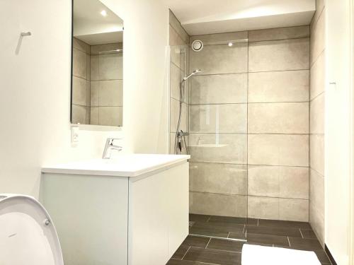 a bathroom with a shower and a sink and a toilet at Spacious Apartment for 4 in Esbjerg