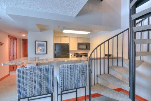 a kitchen and staircase in a home with a counter at Wedgewood Lodge in Breckenridge