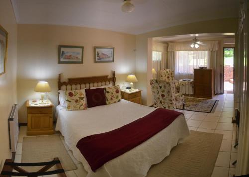 a bedroom with a large bed and a dining room at Brevisbrook B&B in Pietermaritzburg